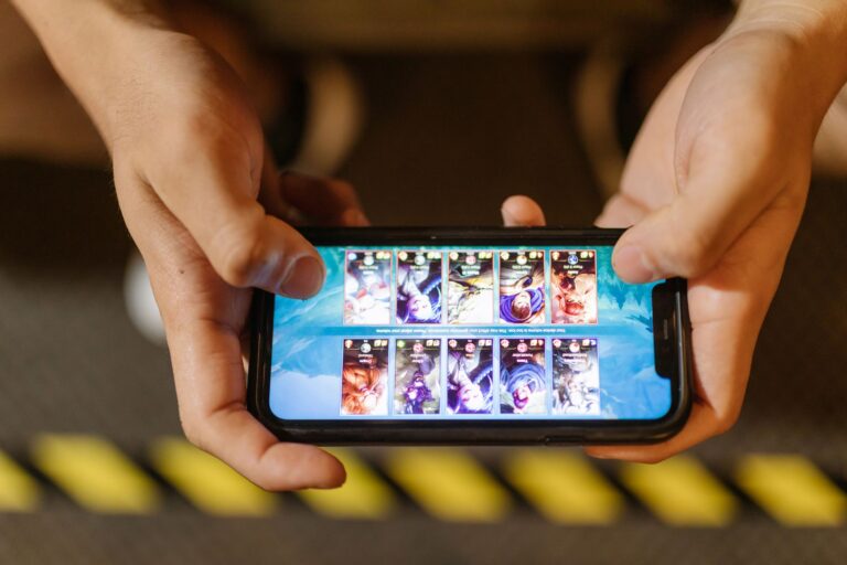 Blizzard’s Warcraft Rumble Silence Is Funneling Players Back to Hearthstone Person playing a mobile strategy game on a smartphone screen