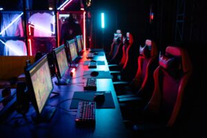 Valve’s Dota 2 Crownfall Act IV Delay Is Reviving Artifact Memories A gaming PC setup with glowing keyboard and monitor displaying a dark fantasy game interface