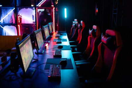 Valve’s Dota 2 Crownfall Act IV Delay Is Reviving Artifact Memories A gaming PC setup with glowing keyboard and monitor displaying a dark fantasy game interface