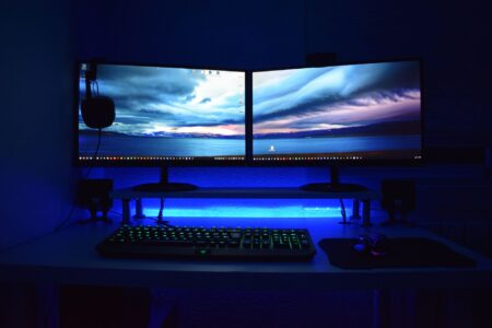 A gaming monitor glowing in a dark room, representing late-night gaming sessions