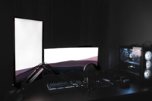 A dark gaming setup with glowing monitor, representing immersive PC gaming culture