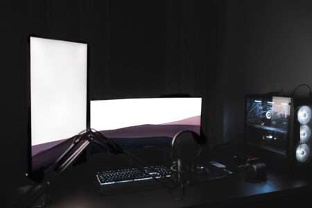 A dark gaming setup with glowing monitor, representing immersive PC gaming culture