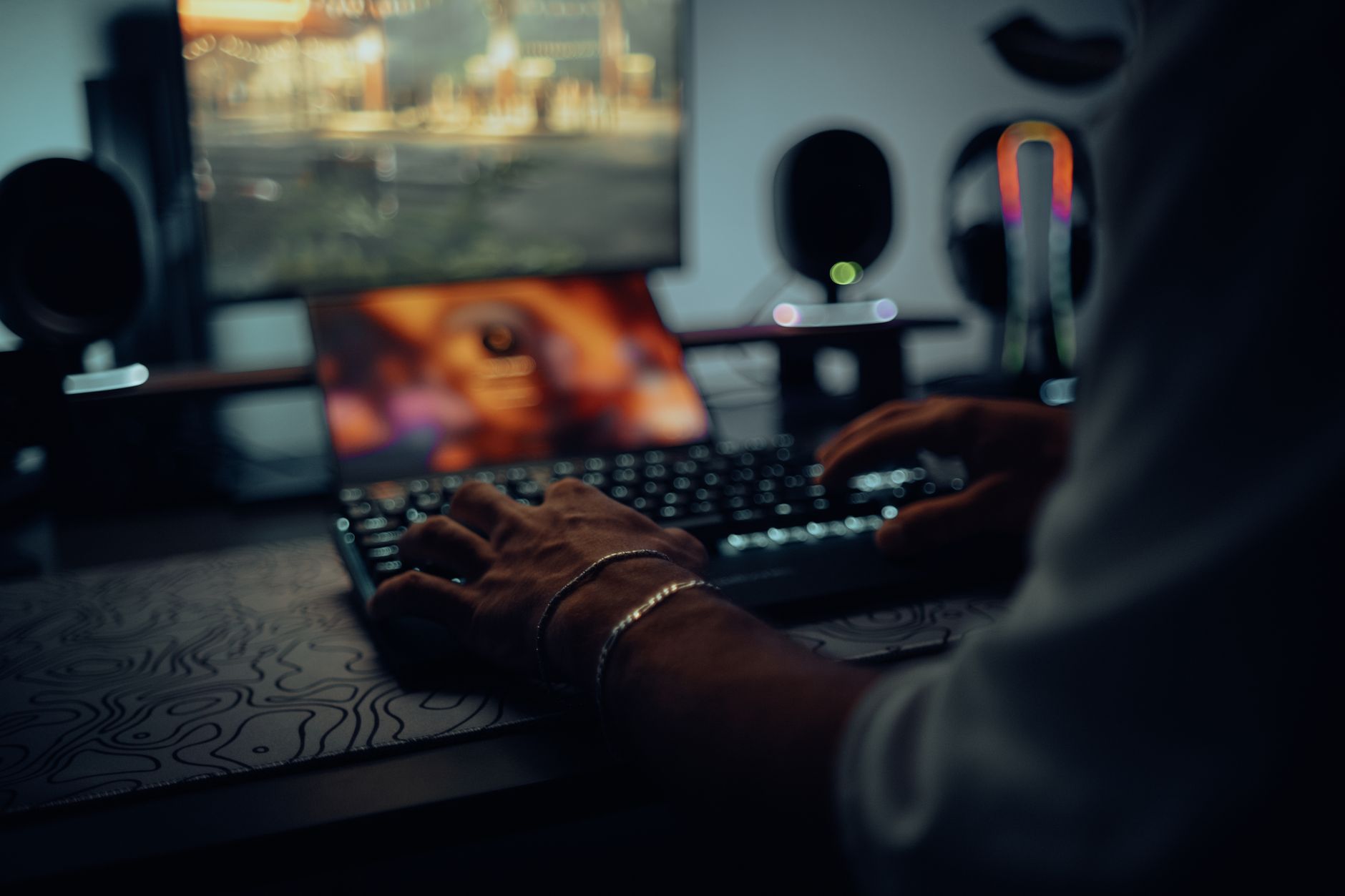 A game development studio workspace with monitors and design materials