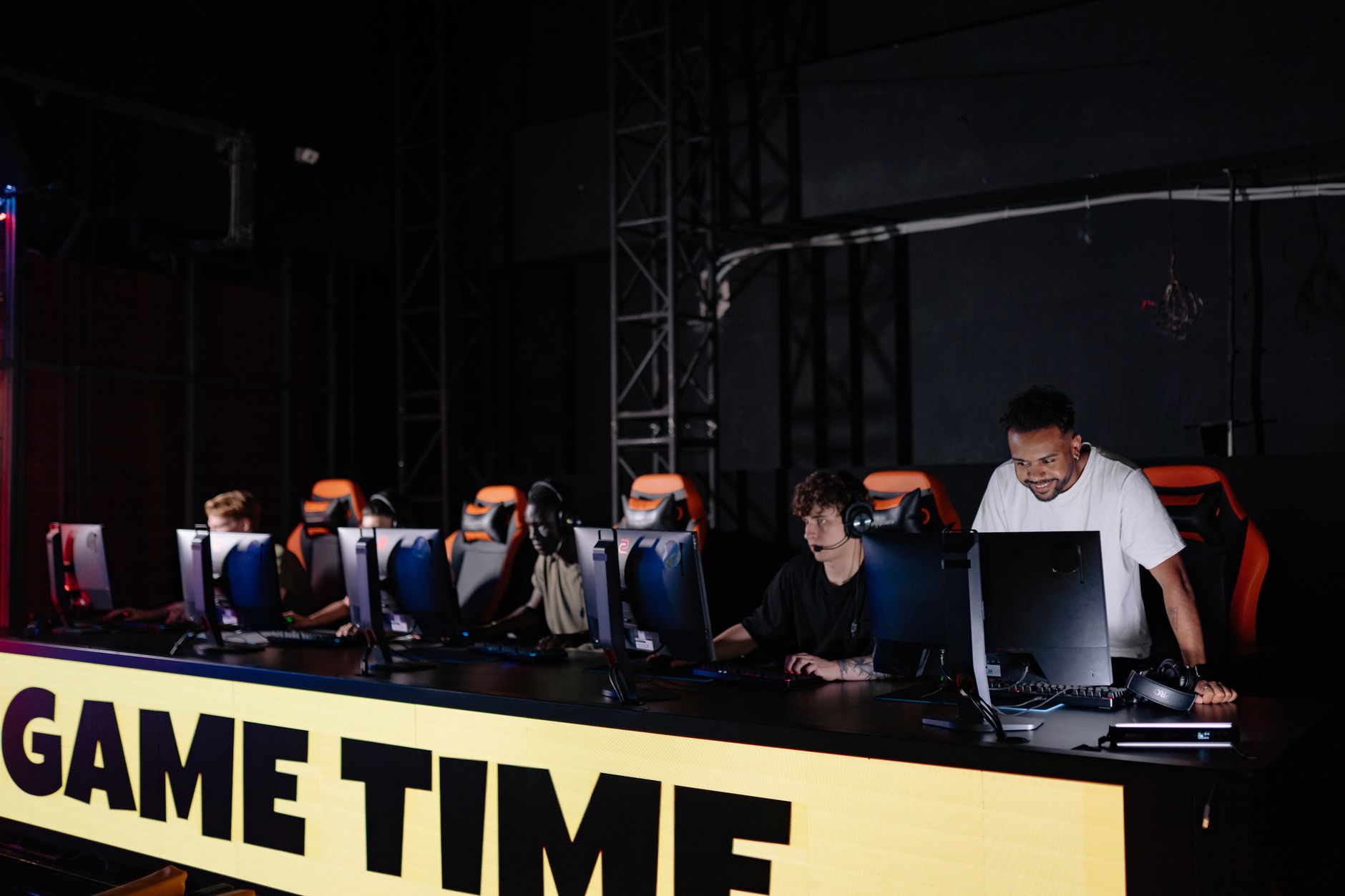 A gaming setup with multiple screens showing online multiplayer action
