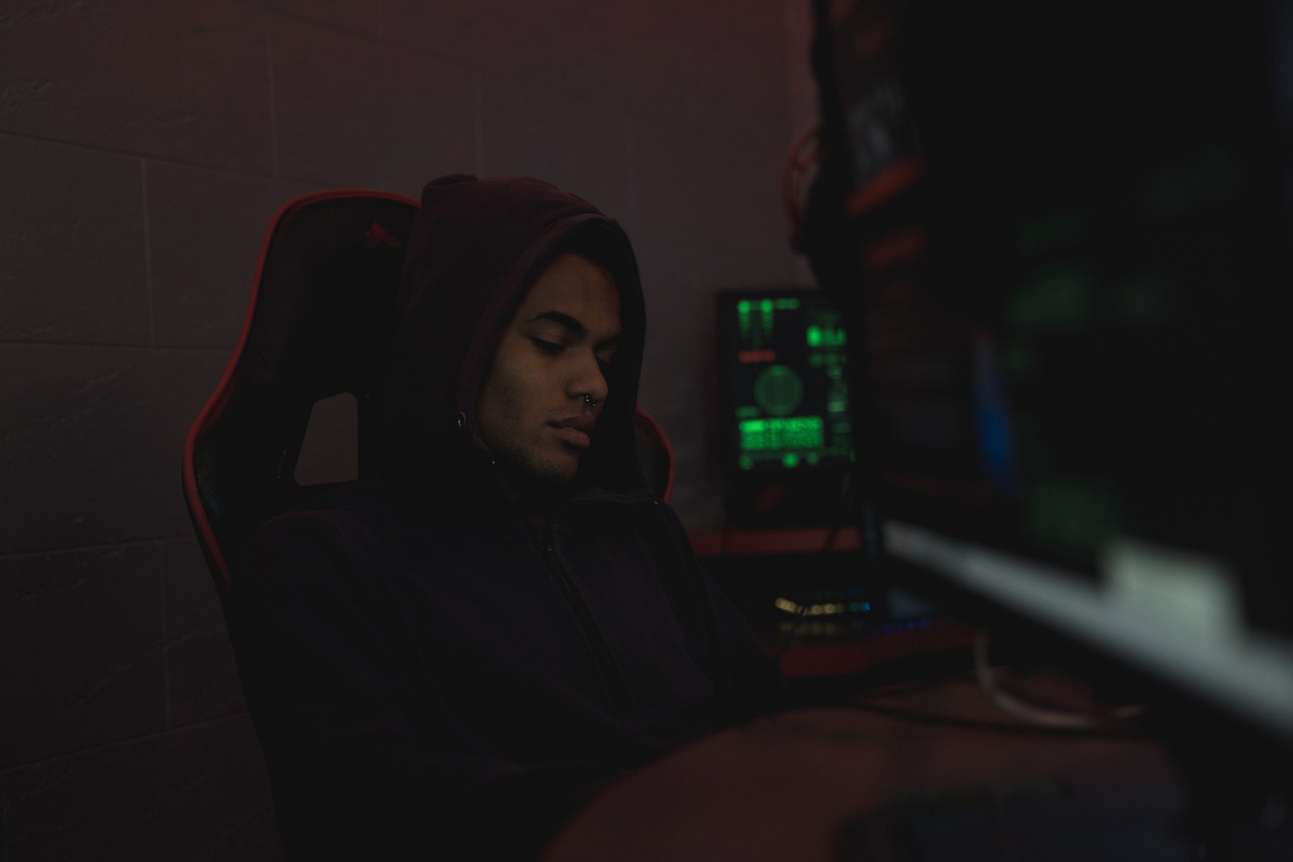 A gamer playing in a dimly lit room, representing the dedicated fighting game community