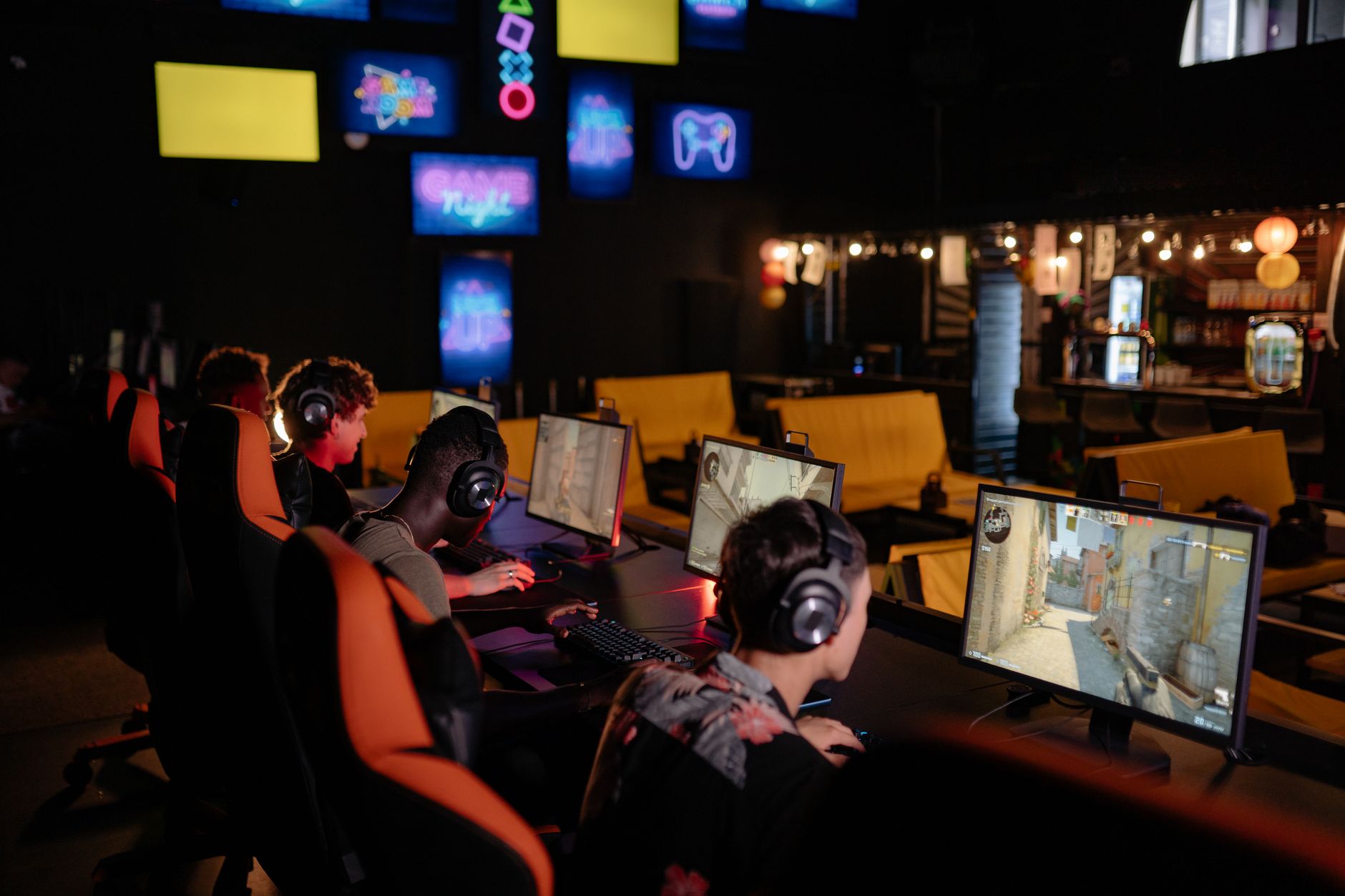 Players gathered around screens discussing games in an online community setting