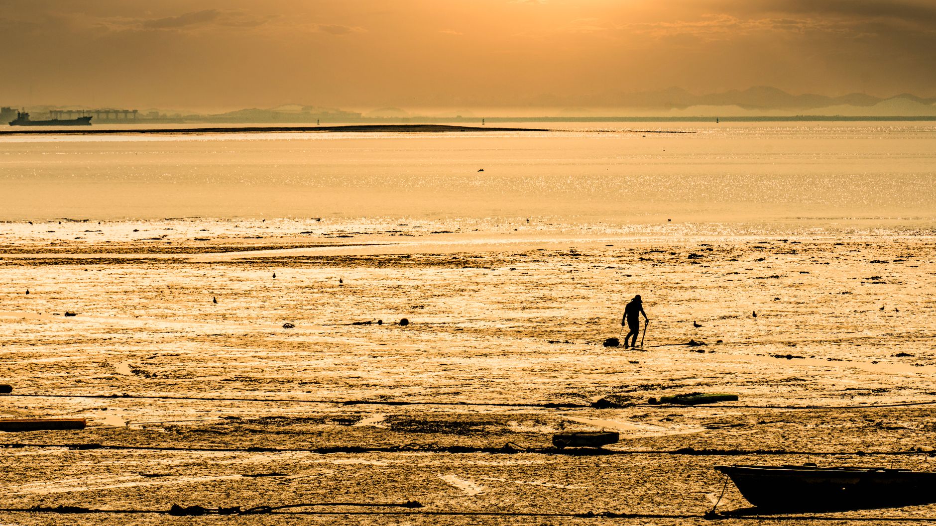 A solitary person walking through a vast open landscape, echoing the isolation themes of games like Death Stranding
