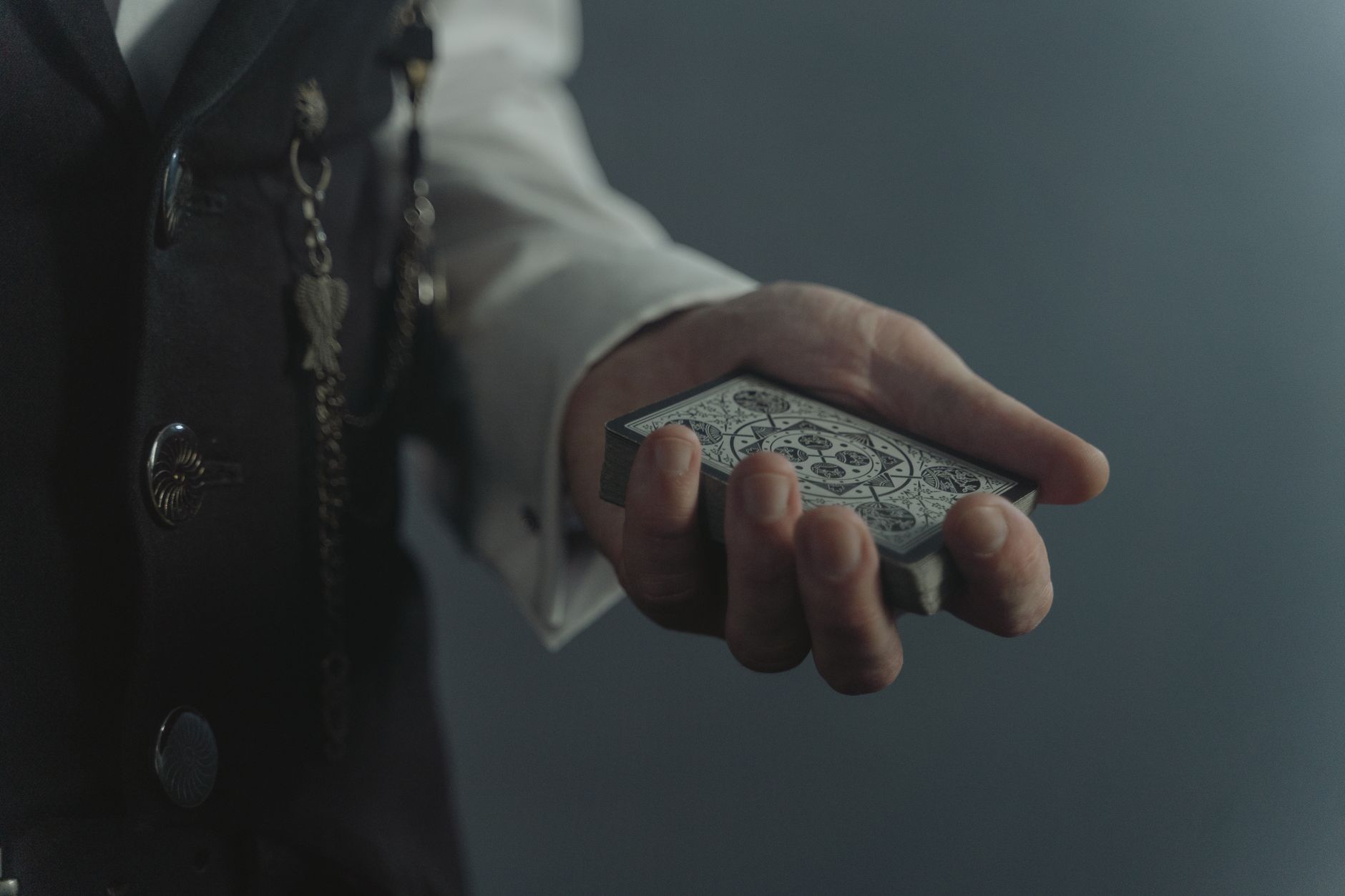 Dark styled playing cards spread on a table, evoking a digital card game aesthetic