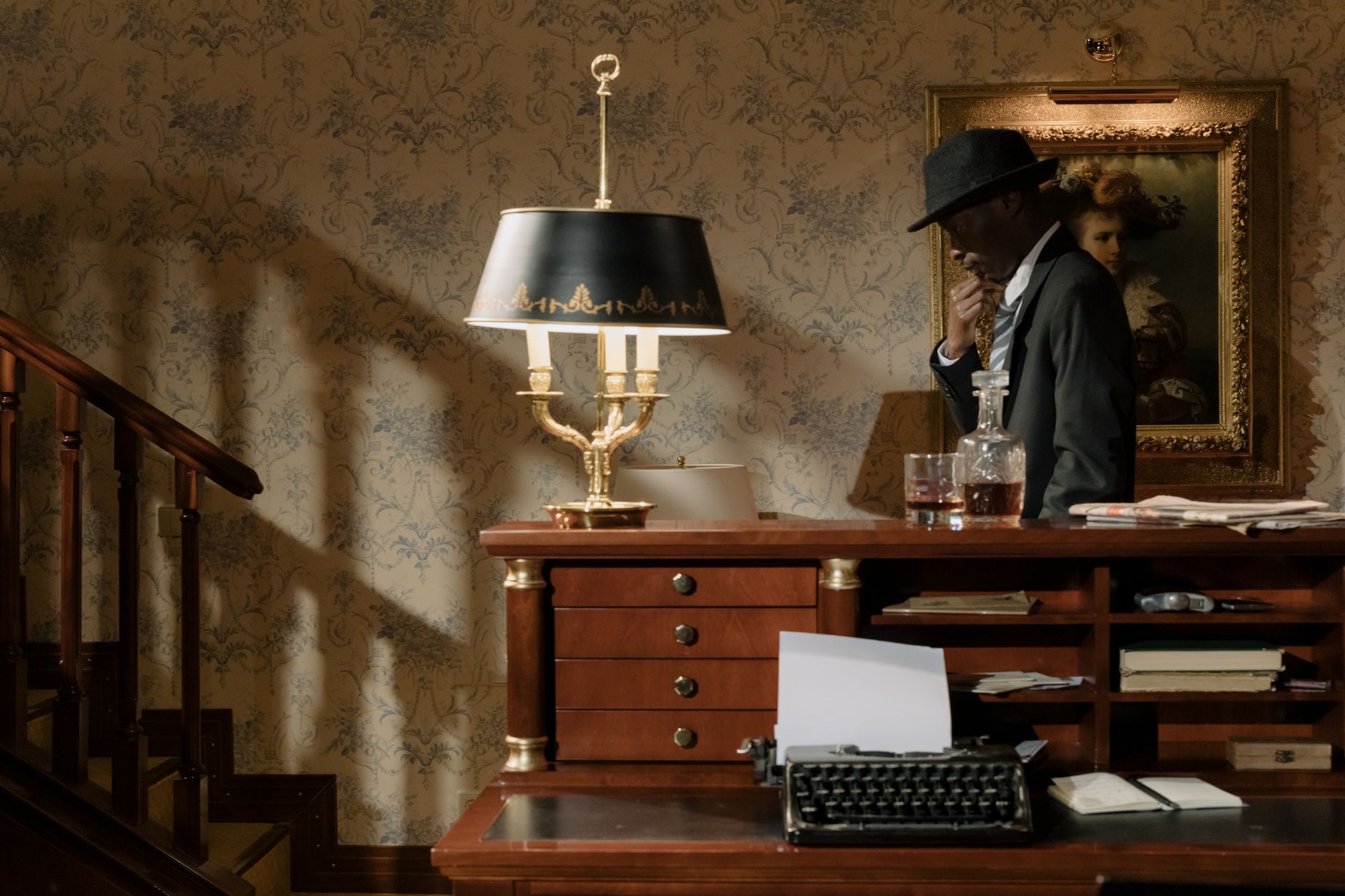 A dimly lit detective desk with scattered papers and a vintage lamp