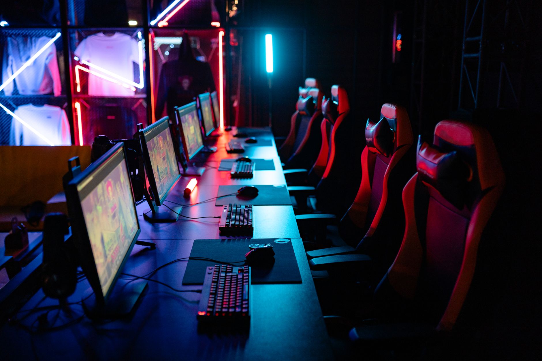 A large esports arena filled with spectators watching a competitive gaming event on a big screen