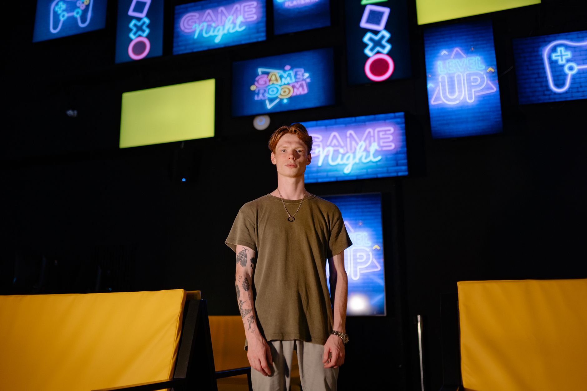 A player sitting in front of a glowing game screen in a dark room