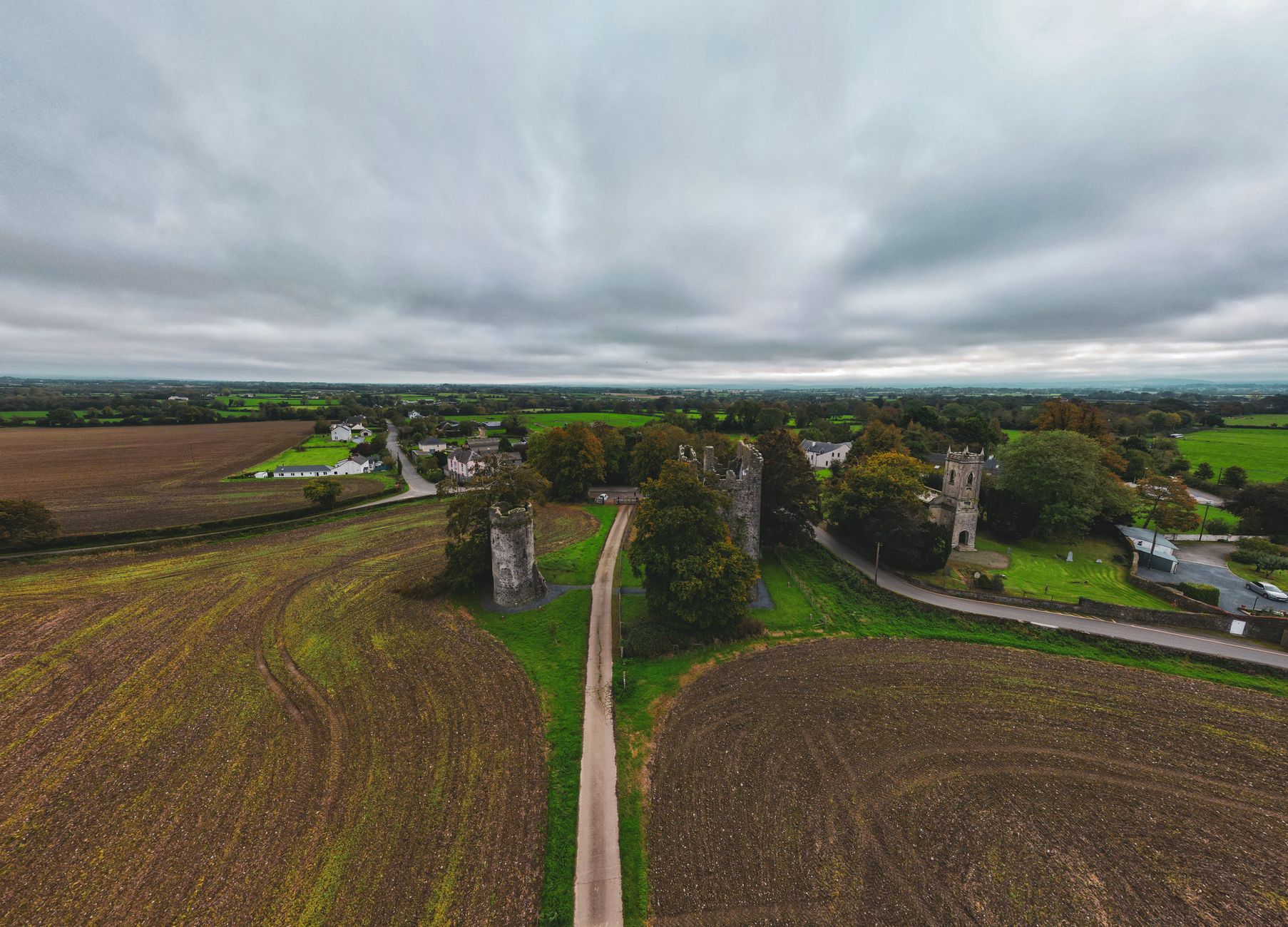 Aerial view of a historic medieval castle surrounded by landscape, evoking the setting of Crusader Kings III