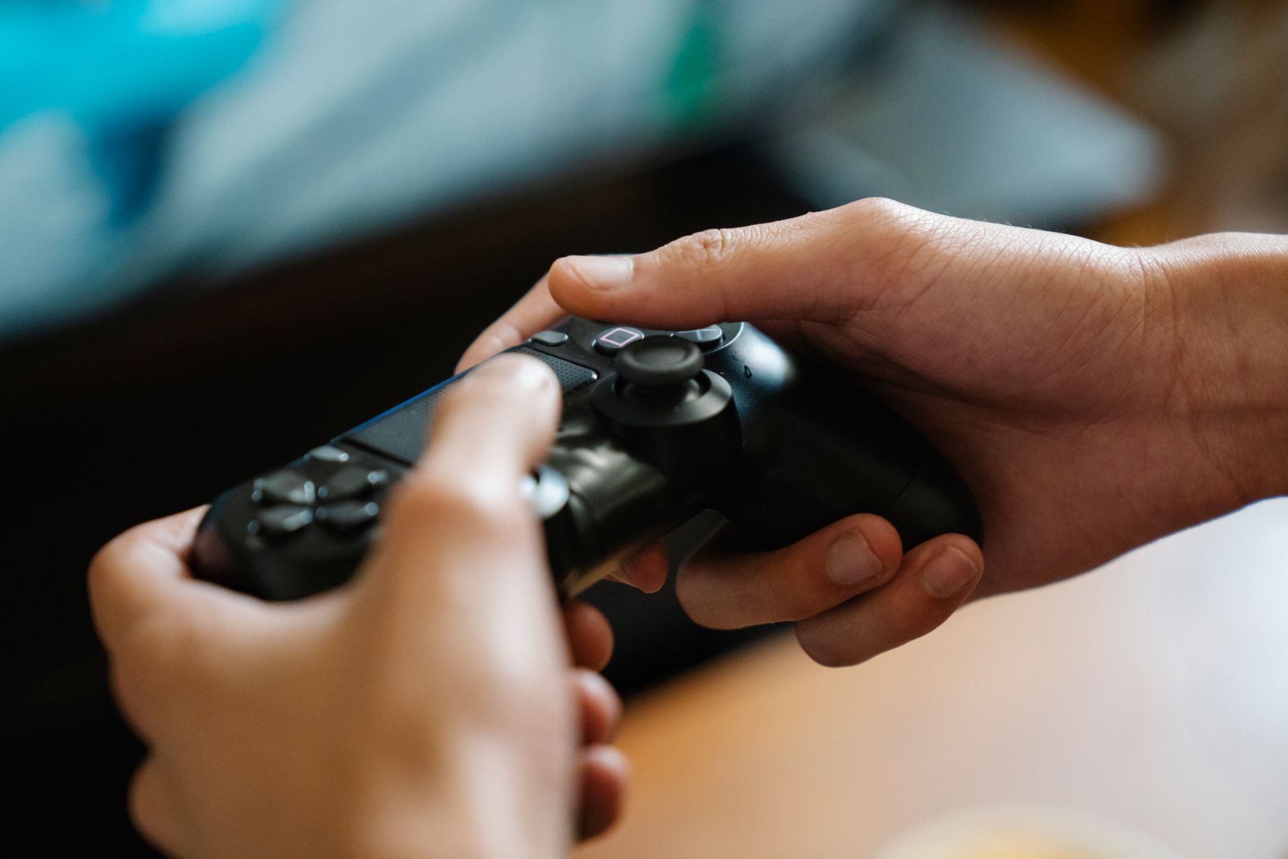 Person playing a console game in a dimly lit room