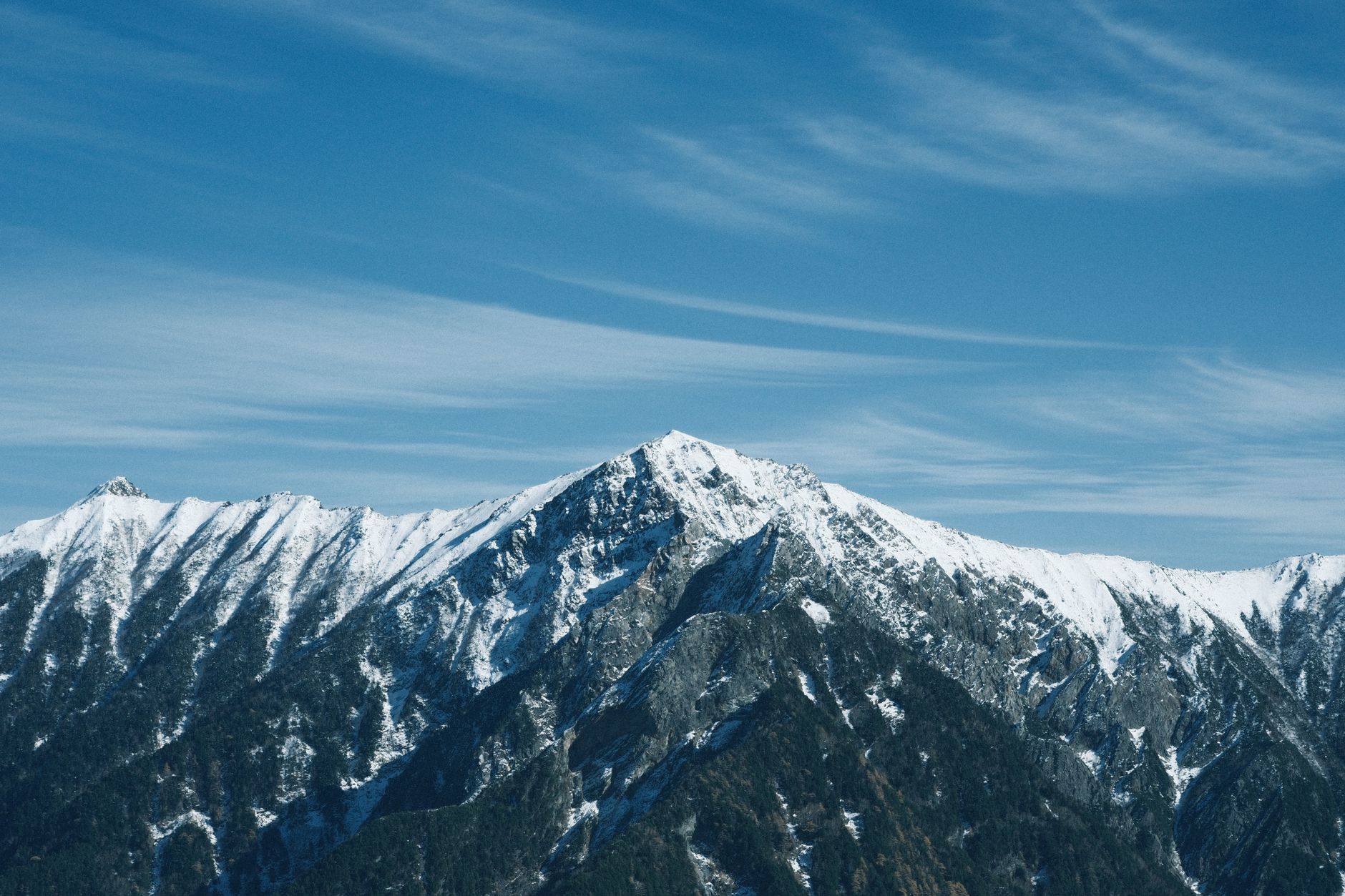 Snowy Japanese mountain terrain similar to the Hokkaido setting of Ghost of Yotei