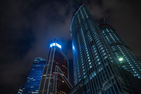 A dark futuristic city skyline representing the atmospheric setting of upcoming sci-fi games like Pragmata