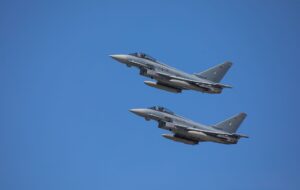 Namco’s Ace Combat Silence Is Sending Fans Back to Zero A military fighter jet flying against a clear blue sky, representing the Ace Combat franchise's aerial combat theme