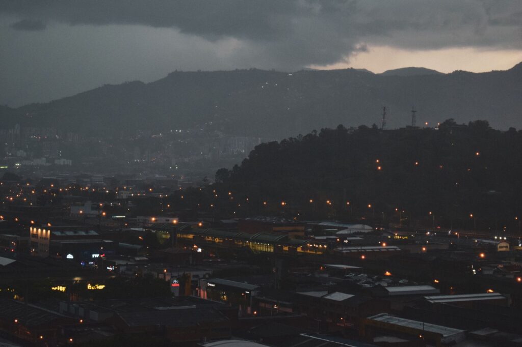 Dark urban cityscape at night evoking an abandoned post-apocalyptic atmosphere