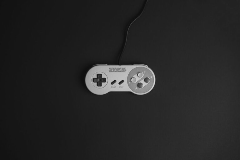 A gaming controller resting on a dark surface, representing console gaming culture