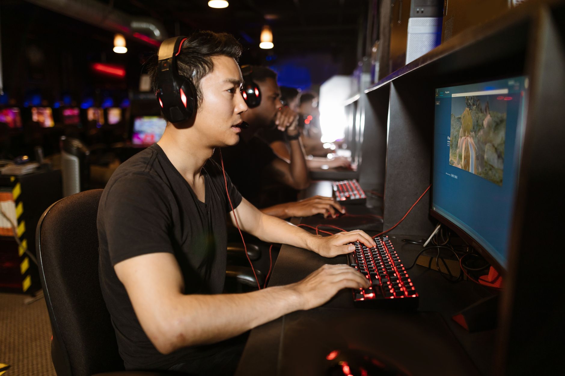 A person playing a video game alone in a dimly lit room
