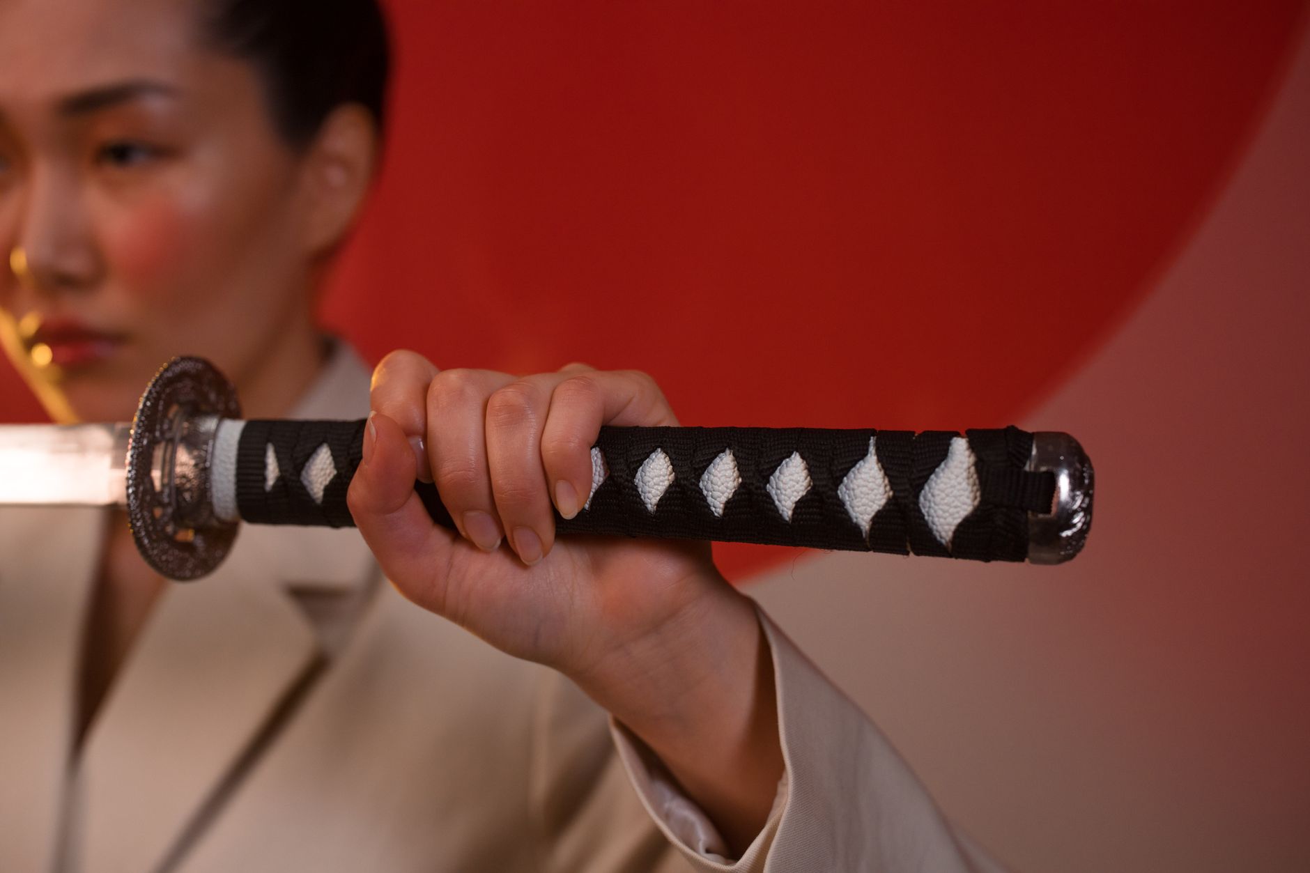 Traditional Japanese samurai swords displayed on a wooden stand, referencing the feudal Japan setting of Yakuza Ishin