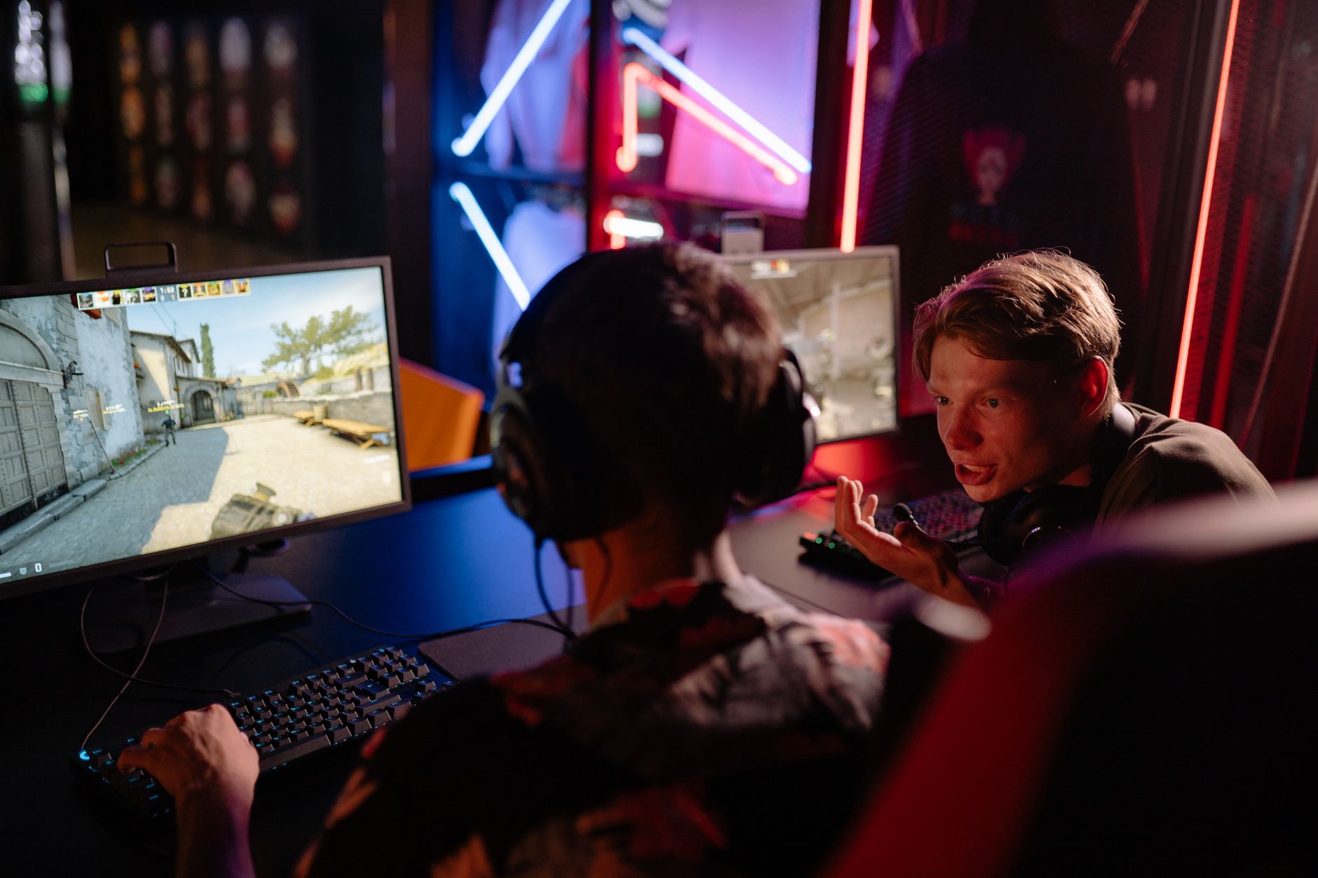 A gaming setup with a monitor glowing in a dark room