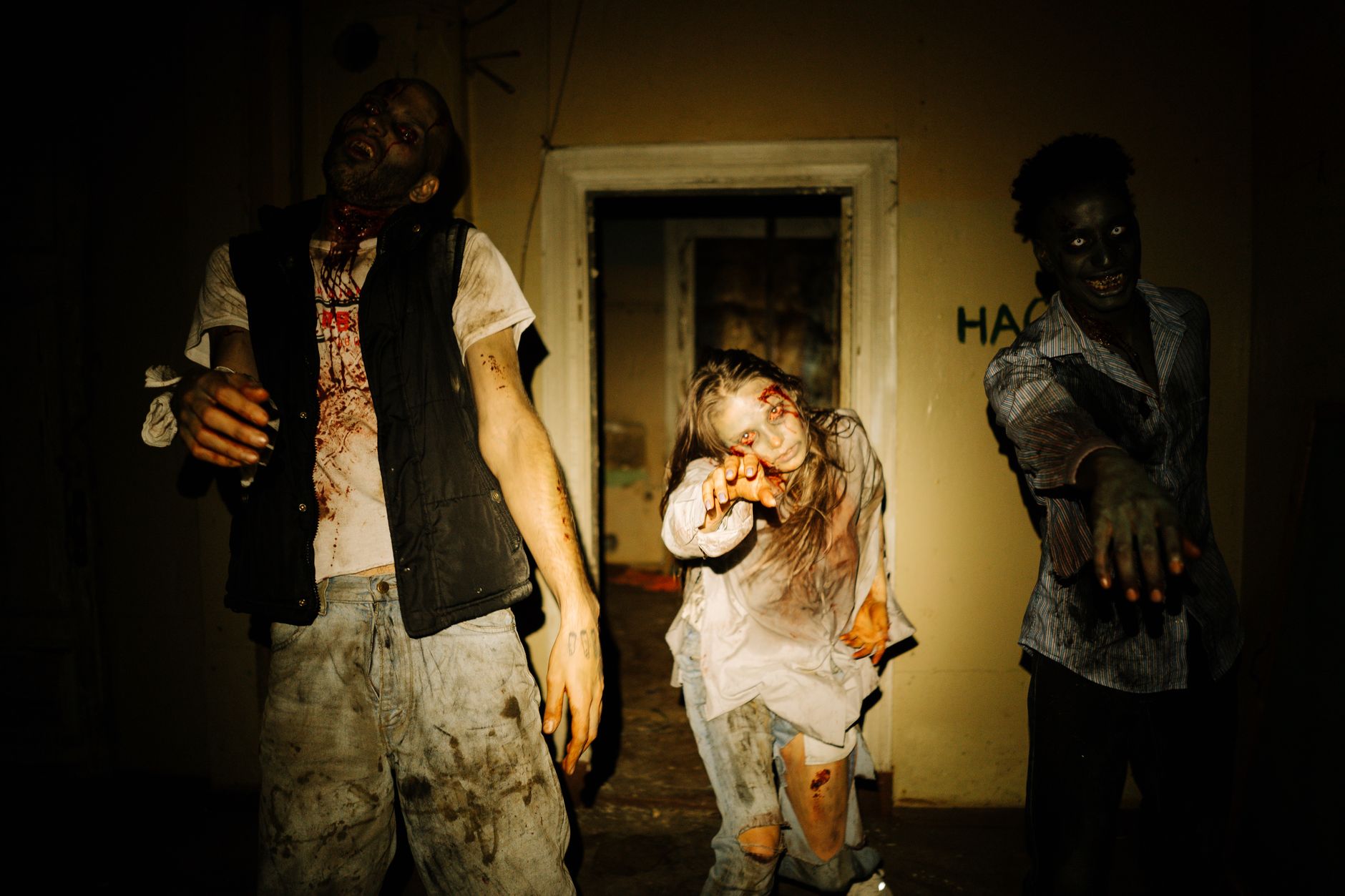 People in zombie costumes at a crowd event referencing horror game themes