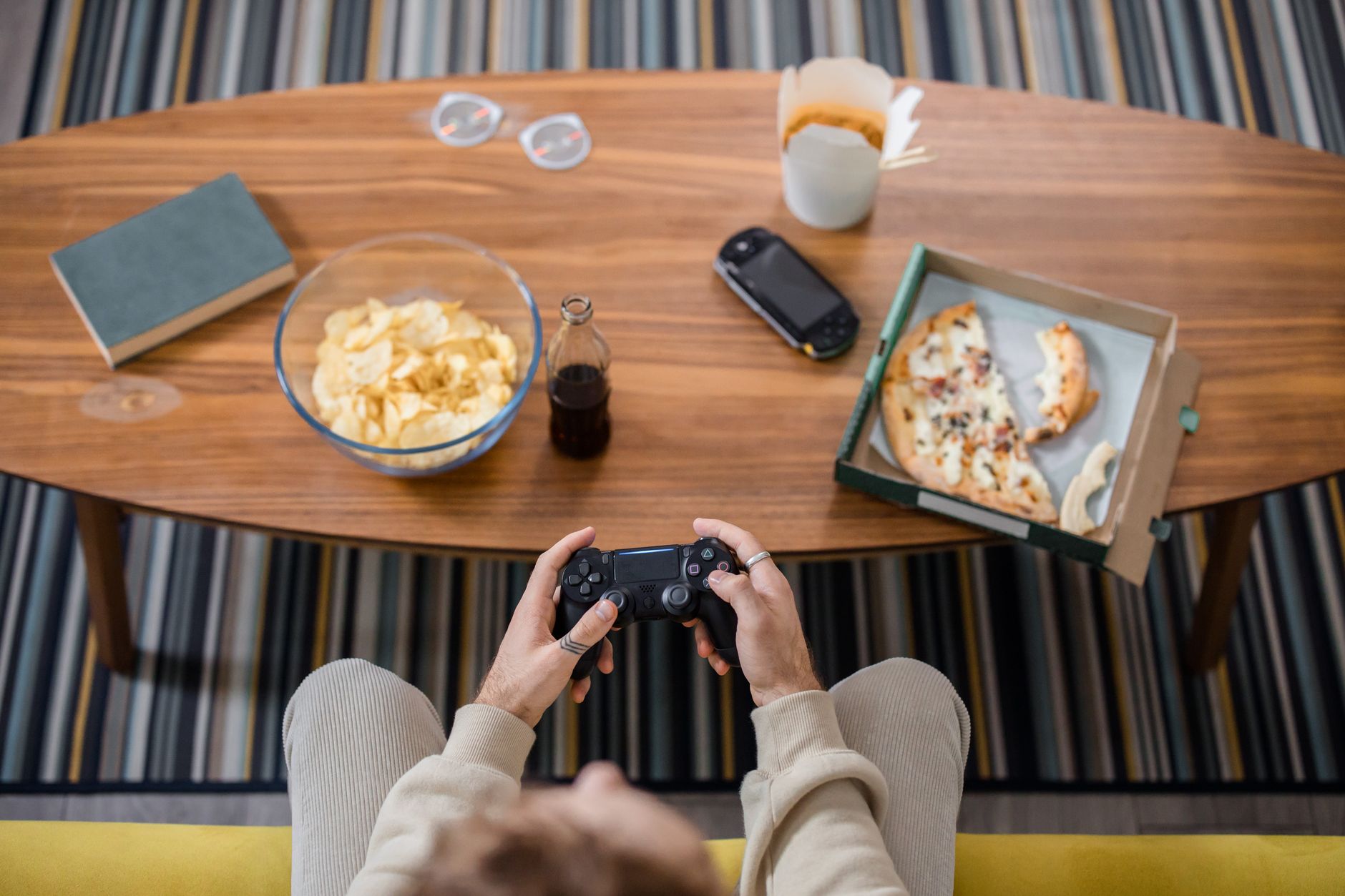 A person playing a console JRPG game in a dimly lit room