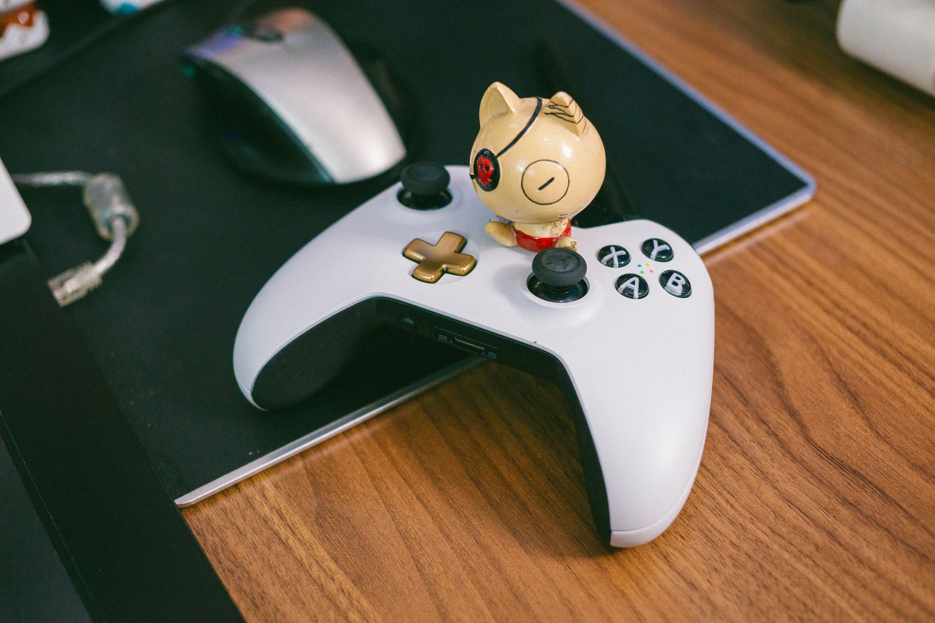 Gaming controller resting on a desk next to a monitor
