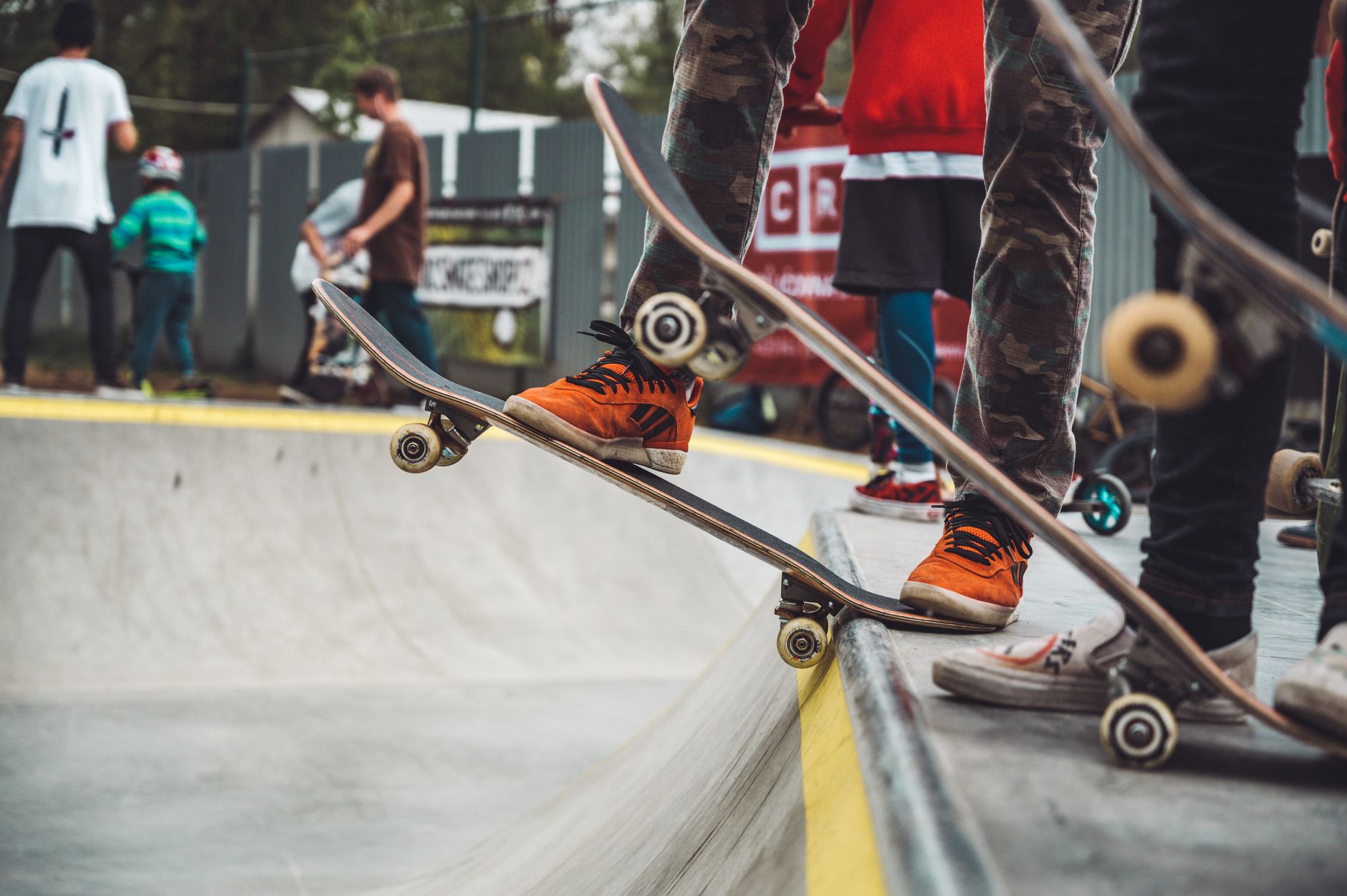 Empty skate park with concrete ramps and rails under open sky