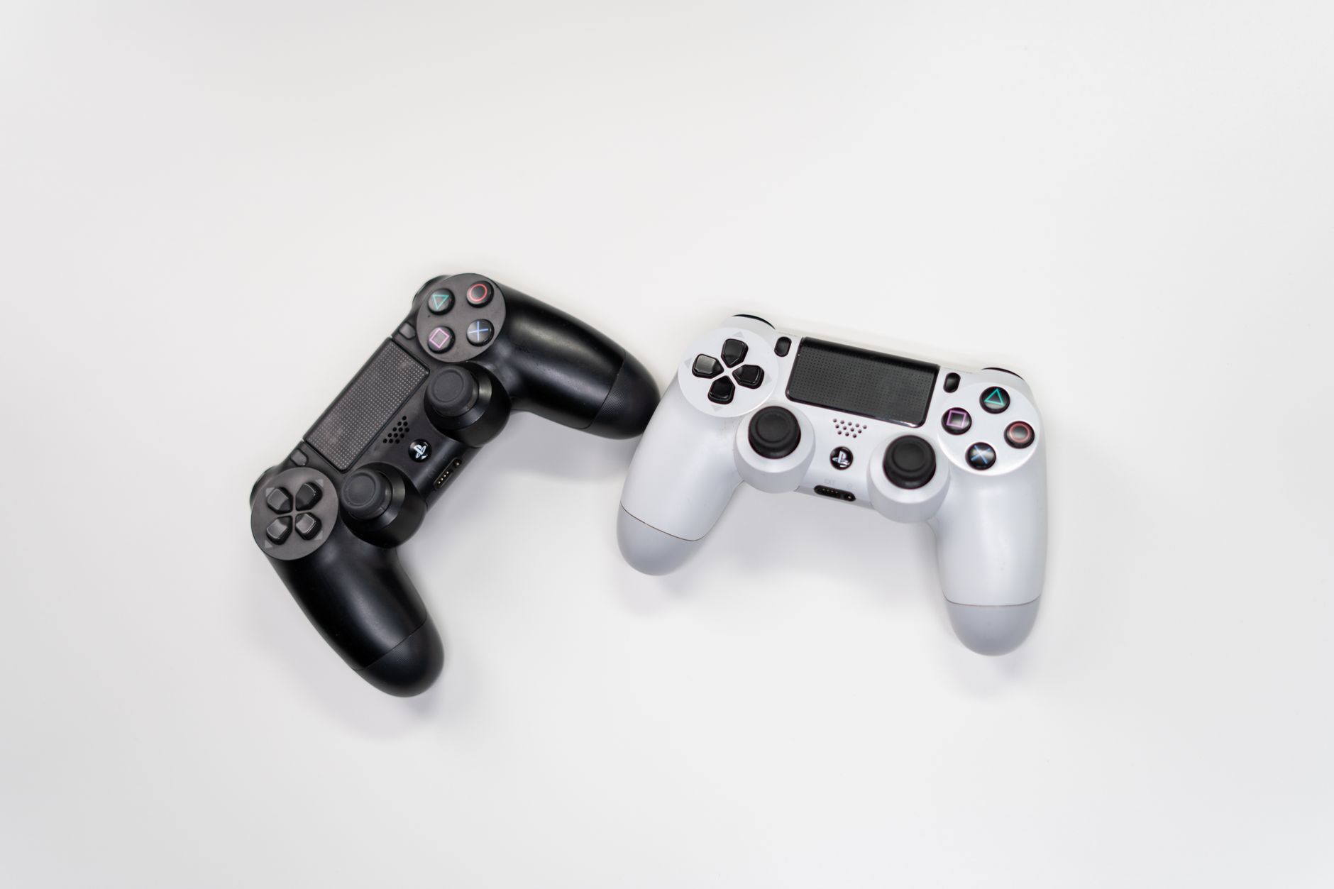 Person holding a gaming controller while playing on a screen