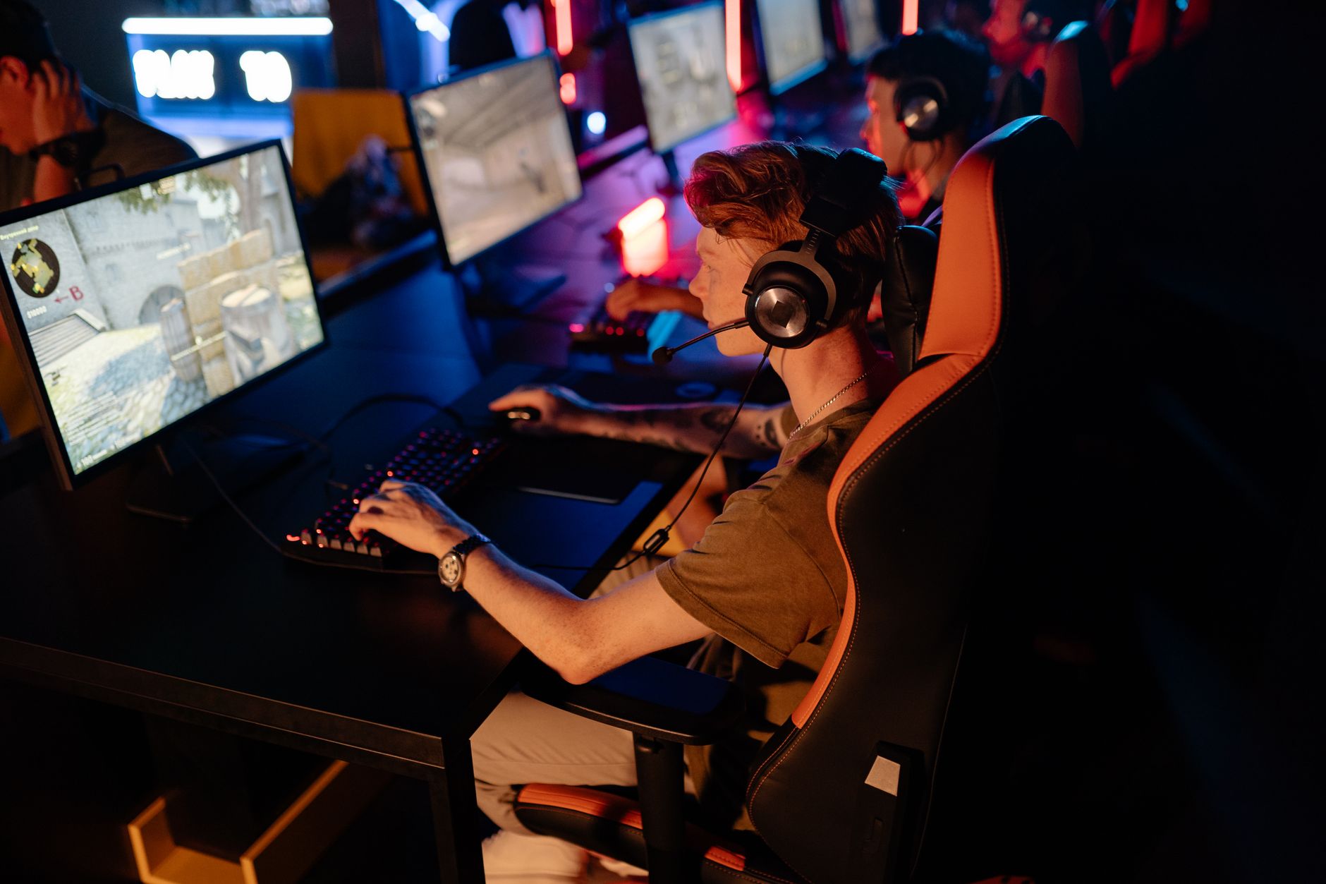 A crowd watching a competitive esports gaming tournament on large screens