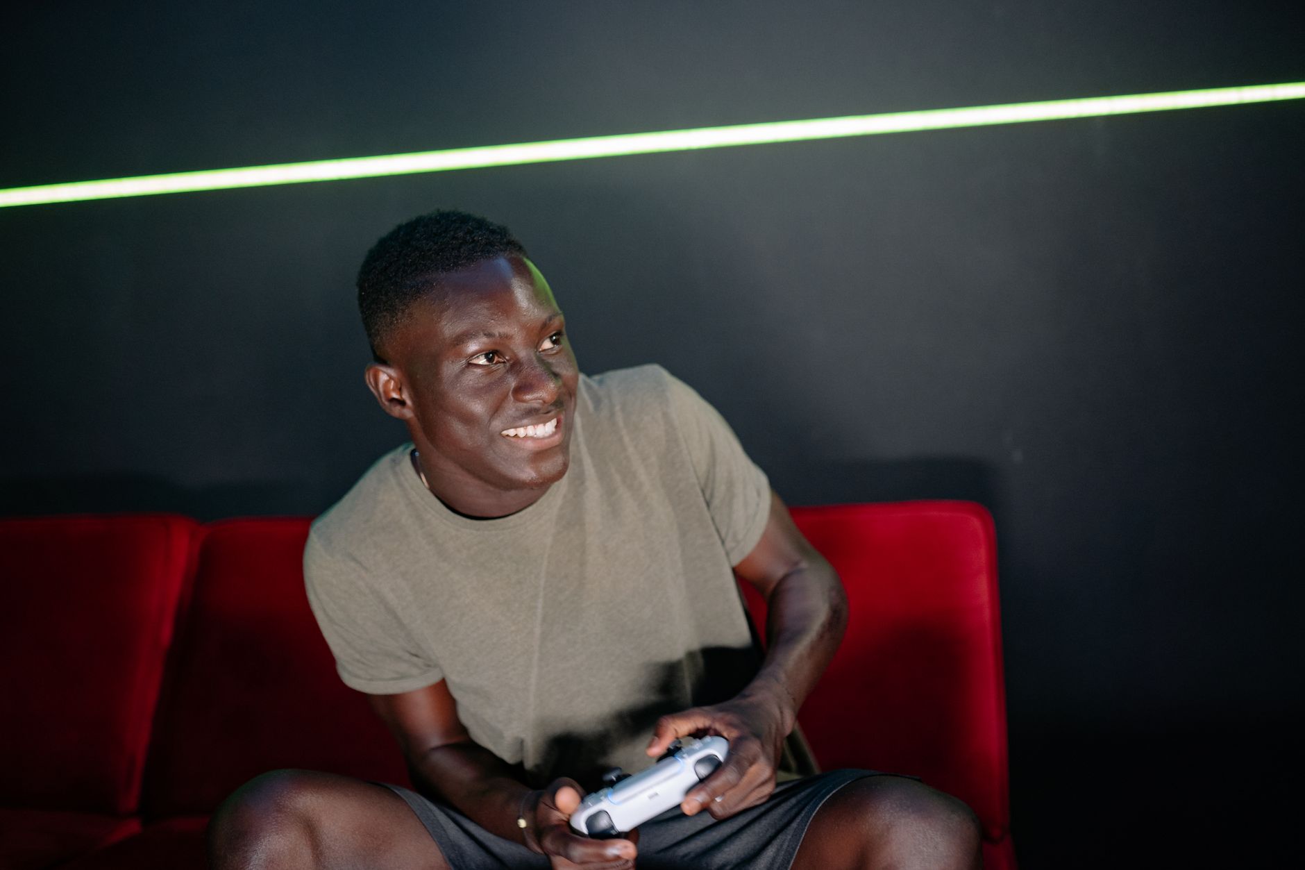 A person playing a video game on a console, reflecting the fan behavior of returning to older entries while awaiting new announcements
