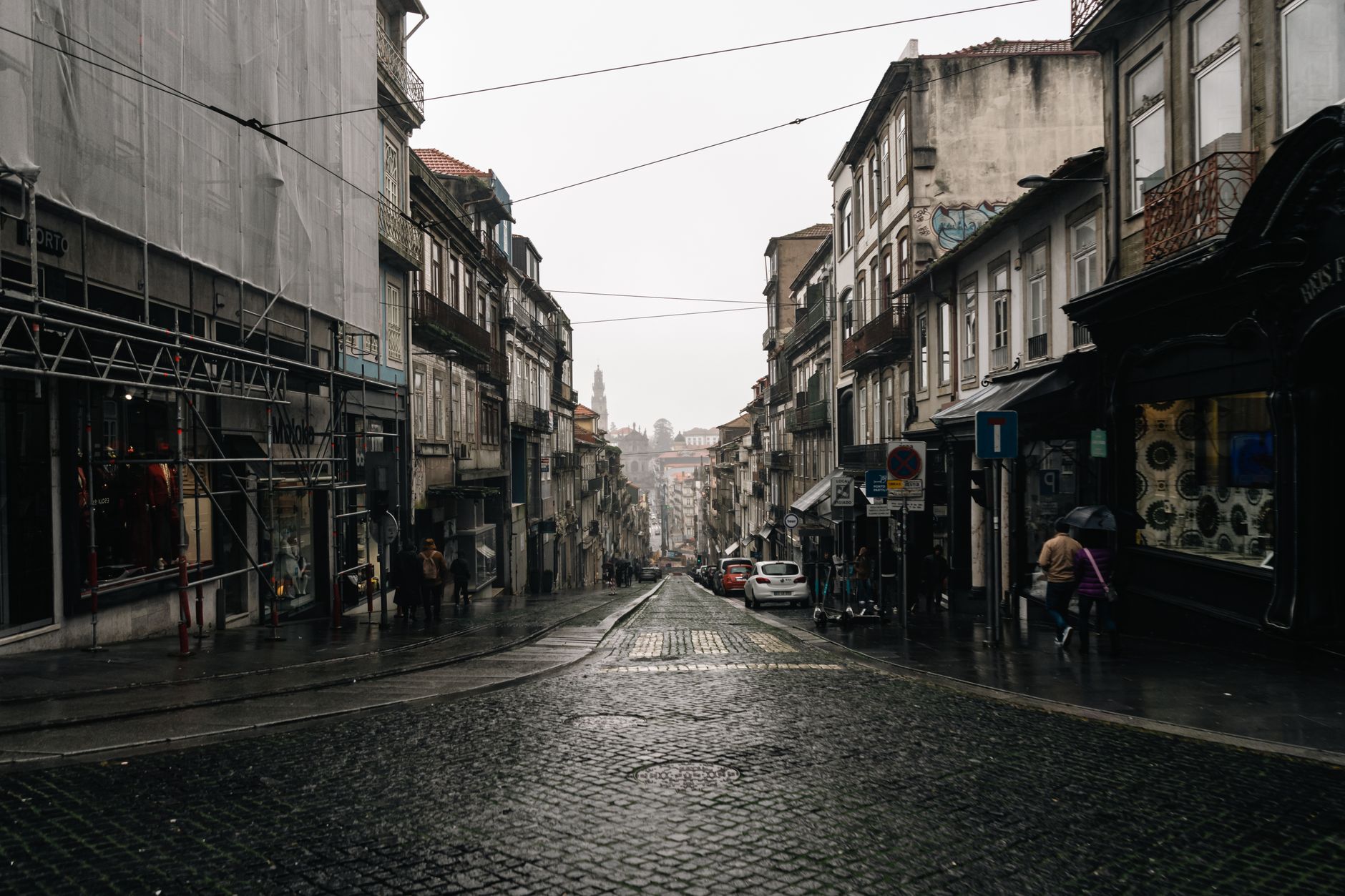 A deserted rain-soaked town street at night