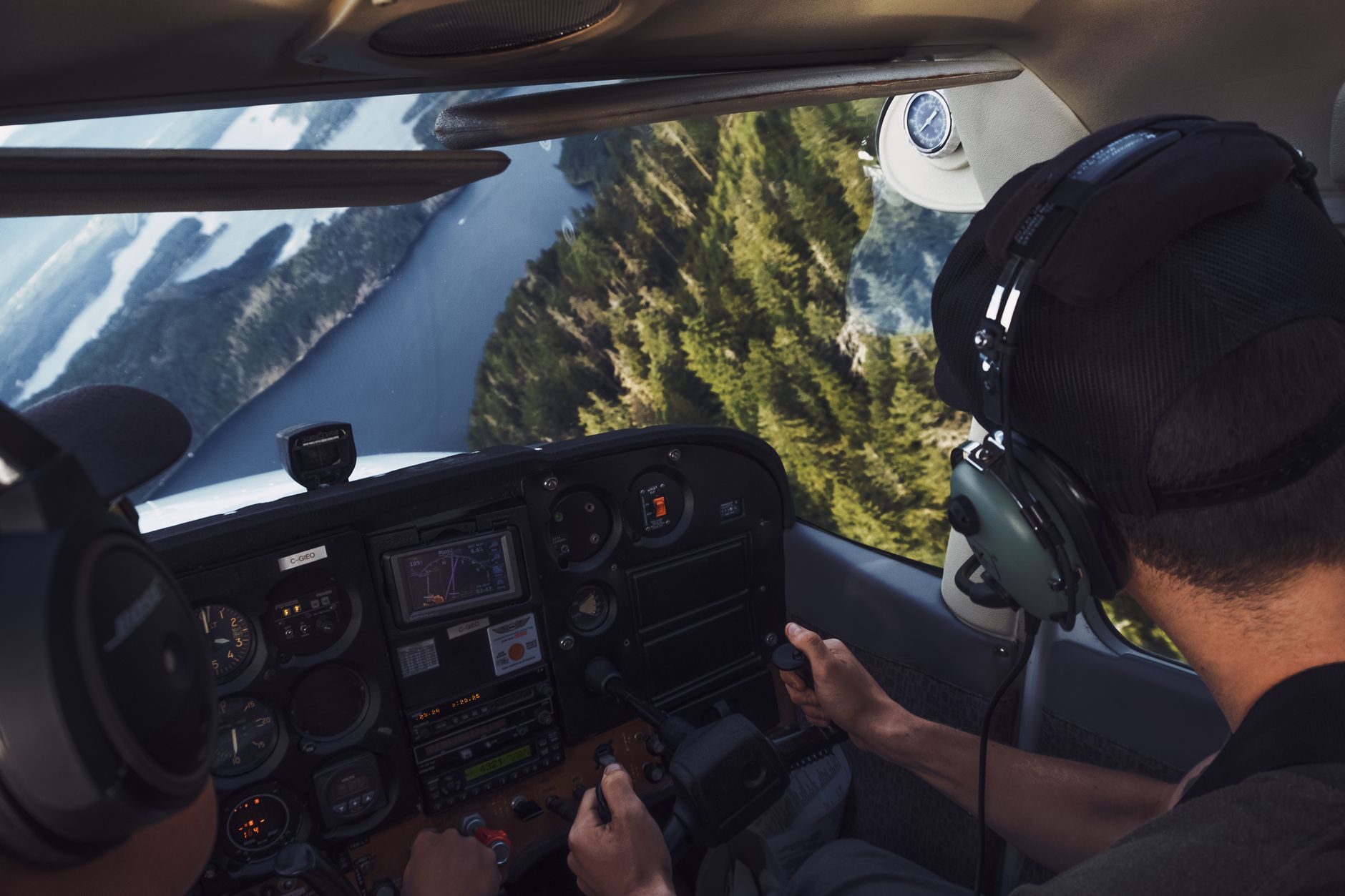 View from inside an aircraft cockpit looking out over clouds, evoking the perspective of Ace Combat gameplay
