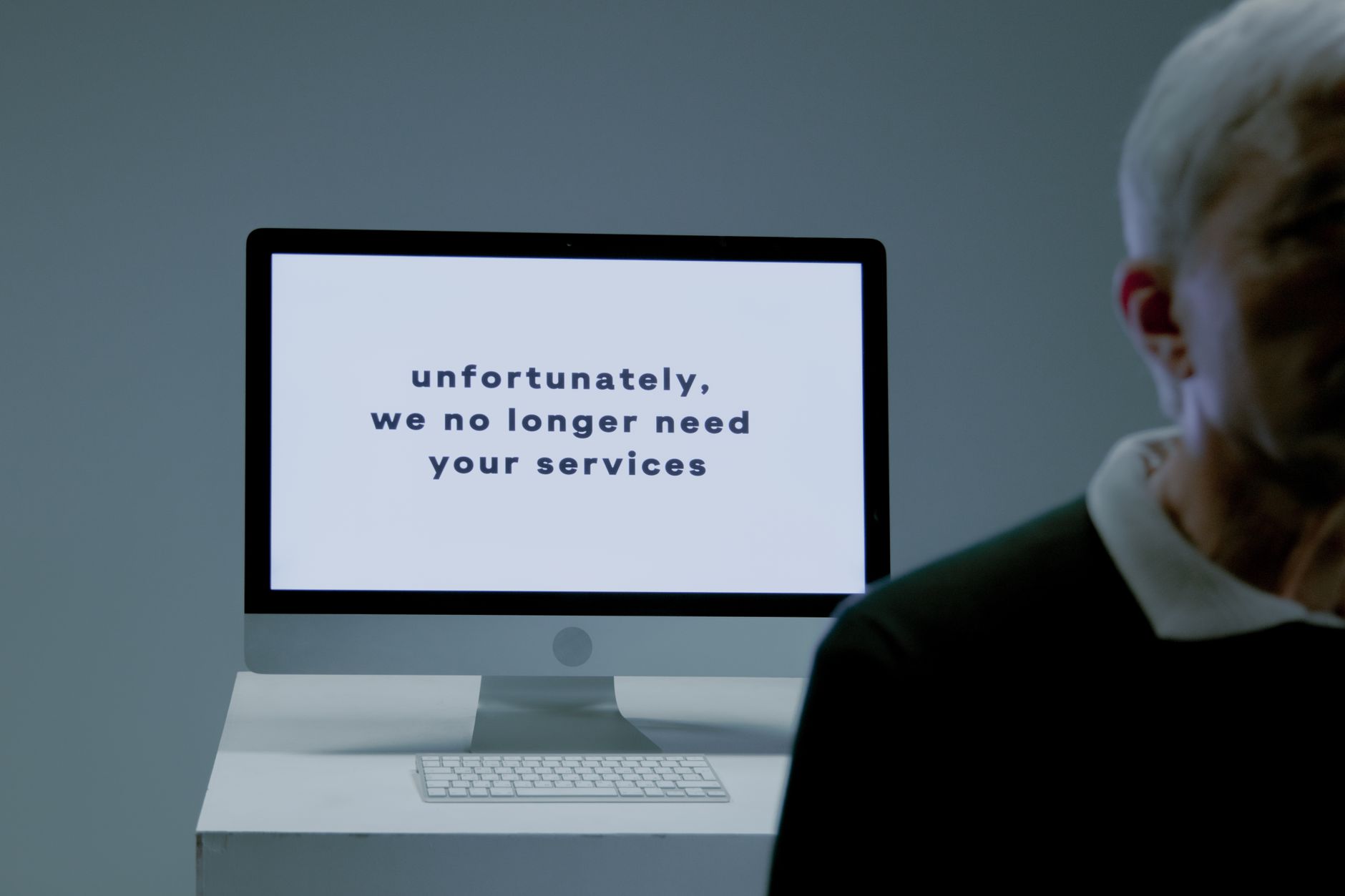 A glowing computer screen in a dimly lit room suggesting anticipation